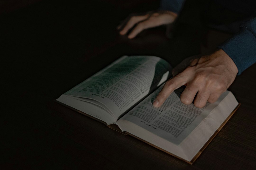 person reading mystery book at night